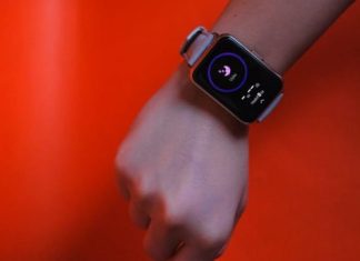 Fist wearing a smartwatch with fitness tracking display on a vibrant orange background.